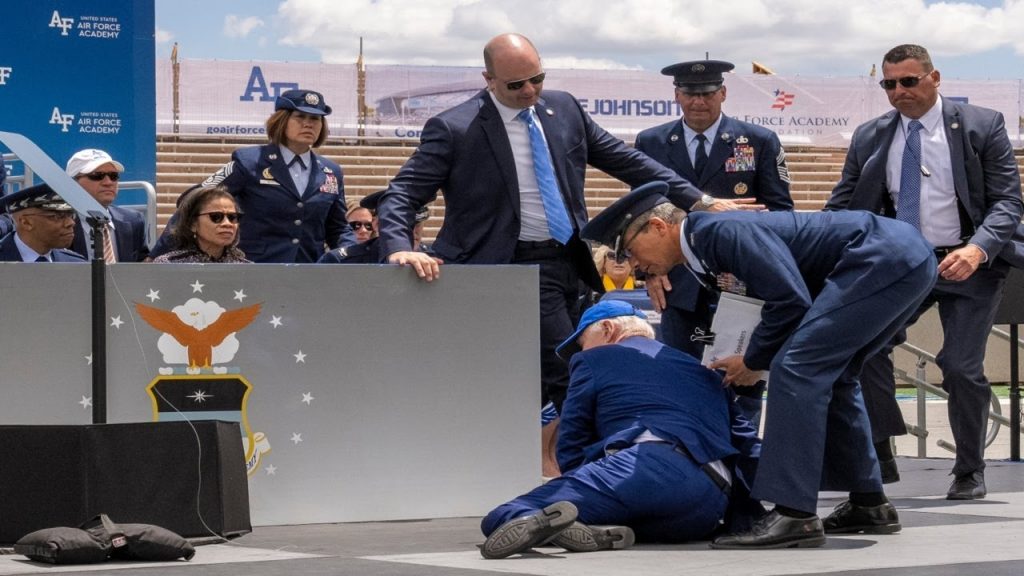 US President Joe Biden trips on stage during Air Force Academy speech